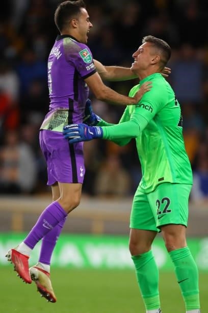 Sergio Reguilon celebrates with Pierluigi Gollini of Tottenham Hotspur after he saves the winning penalty during the Carabao Cup Third Round match...