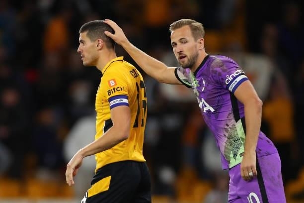 Harry Kane of Tottenham Hotspur consoles Conor Coady of Wolverhampton Wanderers after he misses the decisive penalty during the Carabao Cup Third...