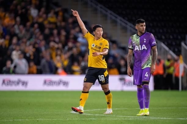 Hee Chan Hwang of Wolverhampton Wanderers and Cristian Romero of Tottenham Hotspur during the Carabao Cup Third Round match between Wolverhampton...