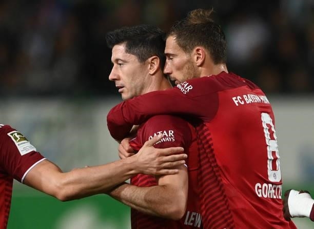 Bayern Munich's Polish striker Robert Lewandowski and Bayern Munich's defender Leon Goretzka celebrate after the third goal for Munich during the...