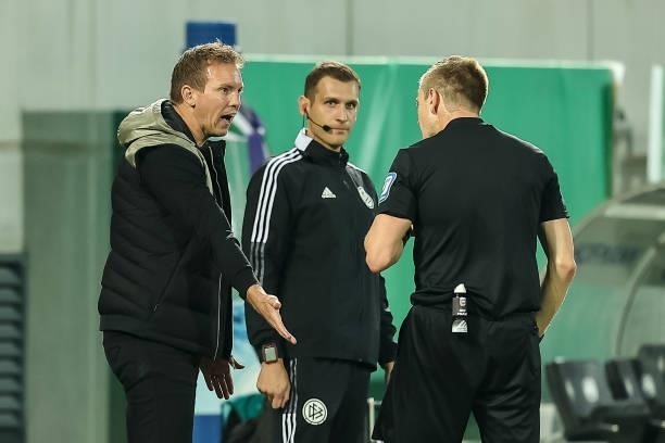 Head coach Julian Nagelsmann of Bayern Muenchen and referee Robert Schroeder to discuss during the Bundesliga match between SpVgg Greuther Fuerth and...