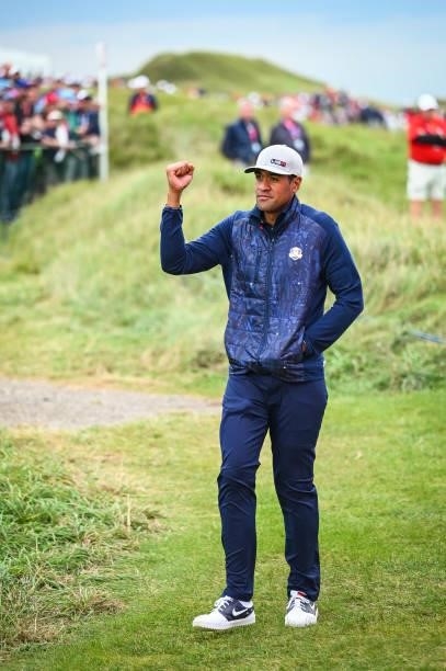 Tony Finau of the U.S. Team celebrates with a fist pump as fans cheer him on during Friday Afternoon Four-ball Matches of the 43rd Ryder Cup at...