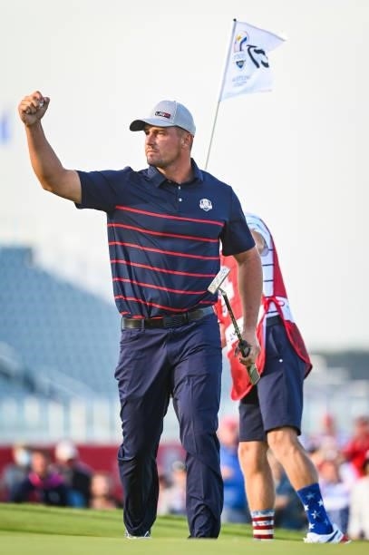 Bryson DeChambeau of the U.S. Team celebrates with a fist pump after making a putt on the 15th hole green during Friday Afternoon Four-ball Matches...