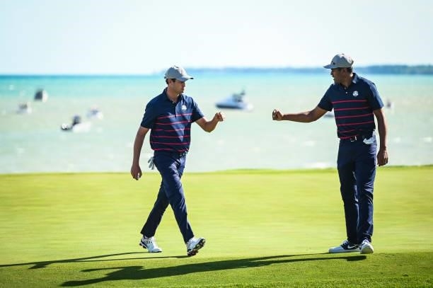 Harris English of the U.S. Team celebrates with Tony Finau after making a birdie putt on the eighth hole green during Friday Afternoon Four-ball...