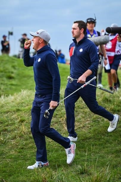 Justin Thomas celebrates and asks fans to make noise after sinking an eagle putt on the 16th hole green during Friday Afternoon Four-ball Matches of...