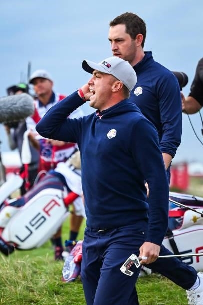 Justin Thomas celebrates and asks fans to make noise after sinking an eagle putt on the 16th hole green during Friday Afternoon Four-ball Matches of...