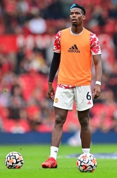Manchester United's French midfielder Paul Pogba warms up ahead of the English Premier League football match between Manchester United and Aston...