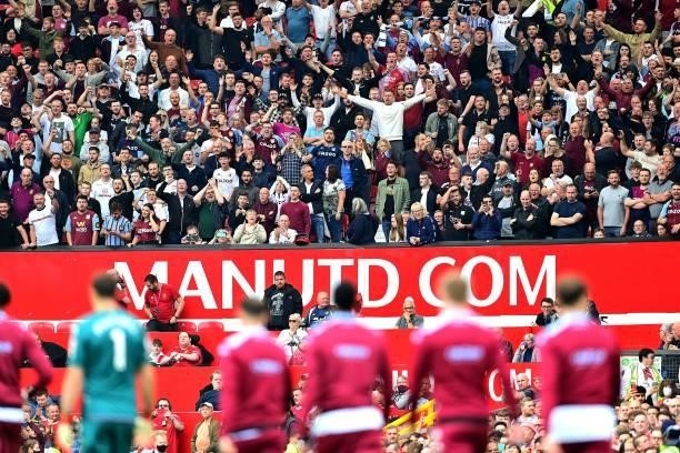 Aston Villa fans cheers as the players arive on the pitch for the English Premier League football match between Manchester United and Aston Villa at...