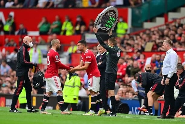 Manchester United's English defender Luke Shaw leaves the pitch after being substituted off for Manchester United's Portuguese defender Diogo Dalot...
