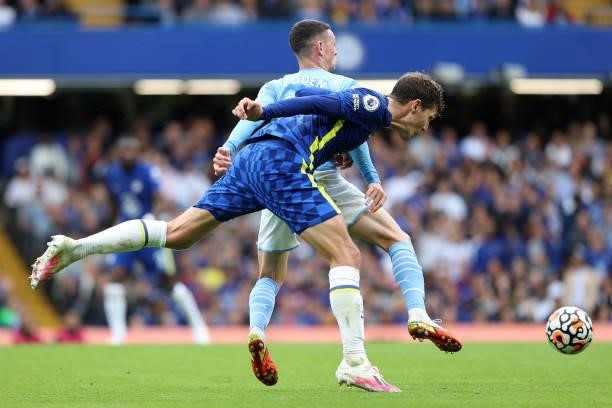 Andreas Christensen of Chelsea heads the ball down and away from Phil Foden of Man City during the Premier League match between Chelsea and...