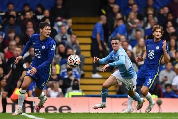 Manchester City's English midfielder Phil Foden vies with Chelsea's Danish defender Andreas Christensen and Chelsea's Spanish defender Marcos Alonso...