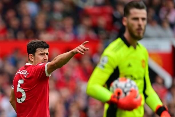 Manchester United's English defender Harry Maguire gestures past Manchester United's Spanish goalkeeper David de Gea after Aston Villa's English...