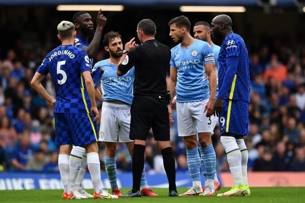 Referee Michael Oliver placates players during the English Premier League football match between Chelsea and Manchester City at Stamford Bridge in...