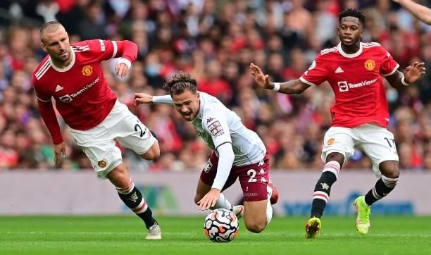 Aston Villa's English defender Matty Cash is fouled by Manchester United's English defender Luke Shaw during the English Premier League football...