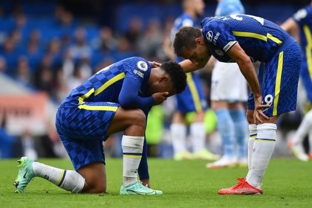 Chelsea's Spanish defender Cesar Azpilicueta consoles Chelsea's English defender Reece James as he reacts to an injury during the English Premier...