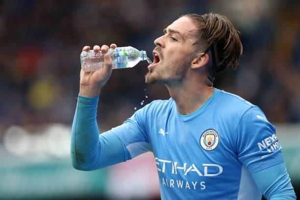 Jack Grealish of Man City seems to get more water around his mouth than in it during the Premier League match between Chelsea and Manchester City at...