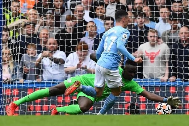 Chelsea's French-born Senegalese goalkeeper Edouard Mendy saves a shot from Manchester City's English midfielder Phil Foden during the English...
