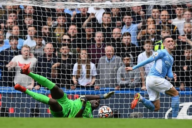 Chelsea's French-born Senegalese goalkeeper Edouard Mendy saves a shot from Manchester City's English midfielder Phil Foden during the English...