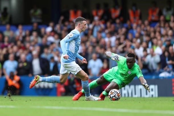 Chelsea goalkeeper Edouard Mendy saves at the feet of Phil Foden of Man City during the Premier League match between Chelsea and Manchester City at...