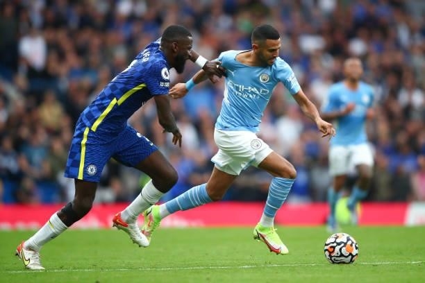 Riyad Mahrez of Manchester City in action with Antonio Rudiger of Chelsea during the Premier League match between Chelsea and Manchester City at...