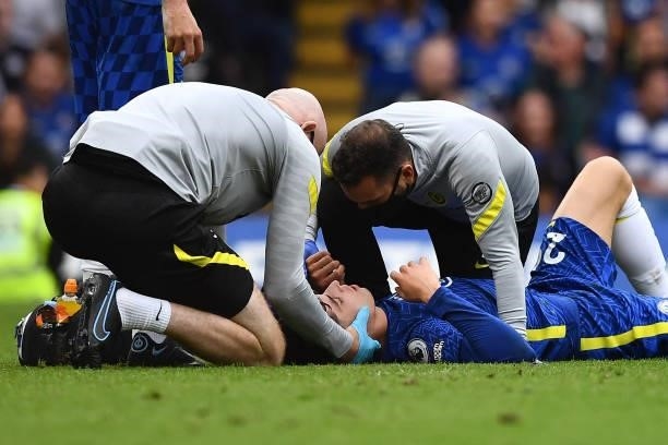 Chelsea's German midfielder Kai Havertz receives medical attention during the English Premier League football match between Chelsea and Manchester...