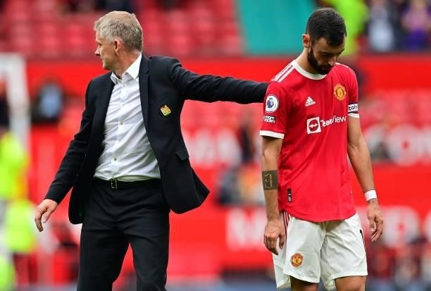 Manchester United's Norwegian manager Ole Gunnar Solskjaer consoles Manchester United's Portuguese midfielder Bruno Fernandes after he missed a...