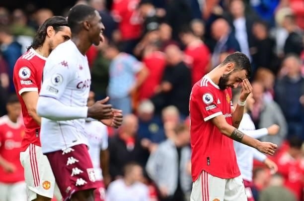 Manchester United's Portuguese midfielder Bruno Fernandes reacts after failing to score from the penalty spot during the English Premier League...