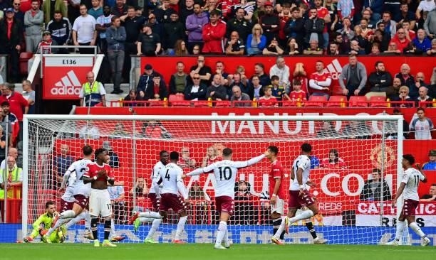 Manchester United's Spanish goalkeeper David de Gea reacts as Aston Villa's English defender Kortney Hause celebrates scoring the opening goal during...