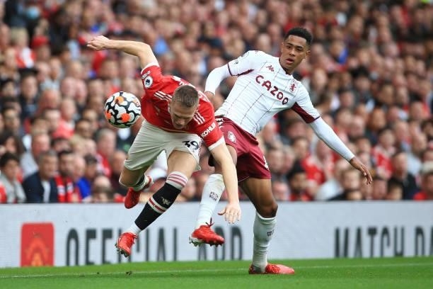 Jacob Ramsey of Aston Villa tackles Scott McTominay of Manchester United during the Premier League match between Manchester United and Aston Villa at...