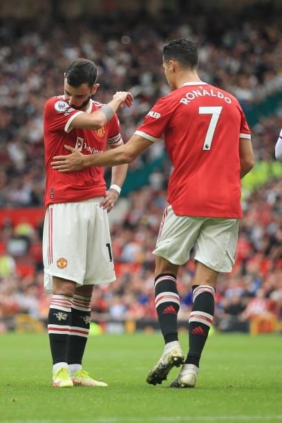Bruno Fernandes of Manchester United is consoled by teammate Cristiano Ronaldo of Manchester United after missing his penalty during the Premier...