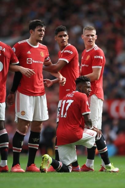 Harry Maguire of Manchester United , Raphael Varane of Manchester United and Scott McTominay of Manchester United stand in the defensive wall in...