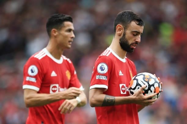 Bruno Fernandes of Manchester United prepares to take his penalty as Cristiano Ronaldo of Manchester United looks on during the Premier League match...