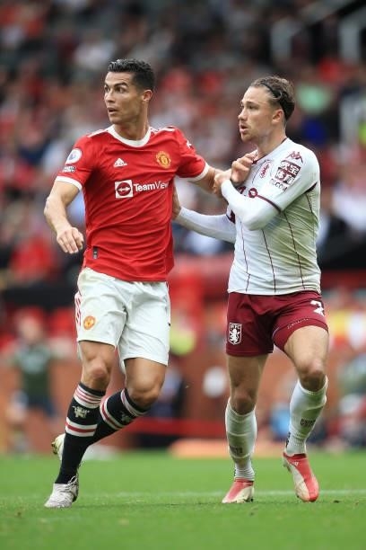 Cristiano Ronaldo of Manchester United tussles with Matty Cash of Aston Villa during the Premier League match between Manchester United and Aston...