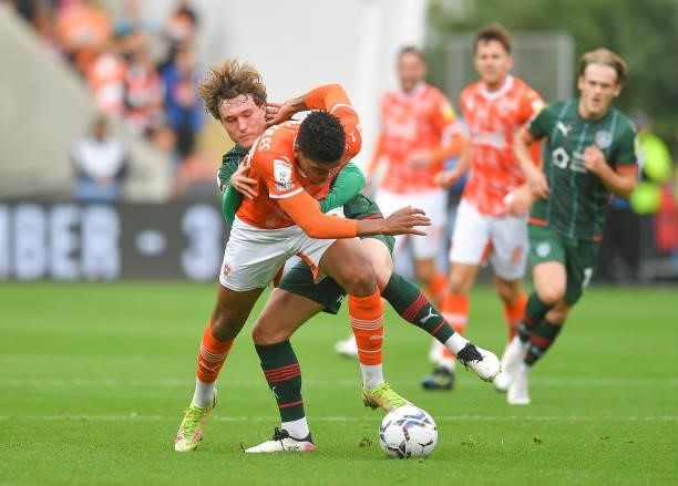 Blackpool's Tyreece John-Jules battles with Barnsley's Callum Styles during the Sky Bet Championship match between Blackpool and Barnsley at...