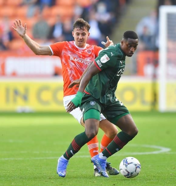 Blackpool's Ryan Wintle battles with Barnsley's Victor Adeboyejo during the Sky Bet Championship match between Blackpool and Barnsley at Bloomfield...