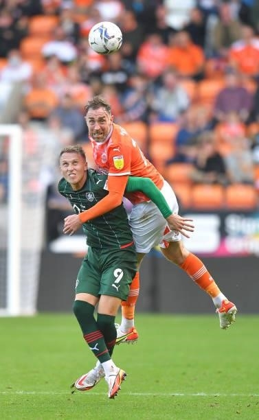 Blackpool's Richard Keogh battles with Barnsley's Cauley Woodrow during the Sky Bet Championship match between Blackpool and Barnsley at Bloomfield...
