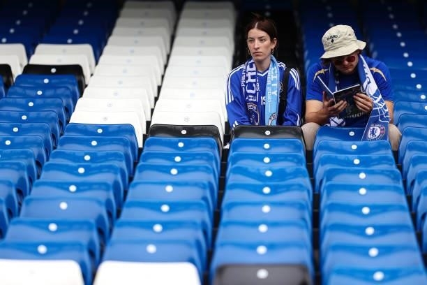 Chelsea fans sit amongst empty seats ahead of the Premier League match between Chelsea and Manchester City at Stamford Bridge on September 25, 2021...