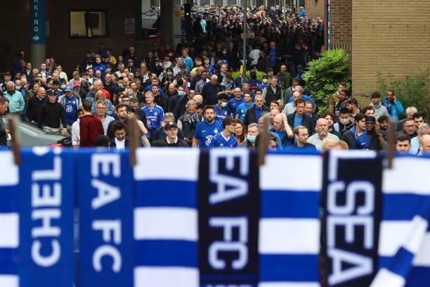 Chelsea fans make their way to the match from the tube station with Chelsea scarves in the foreground ahead of the Premier League match between...