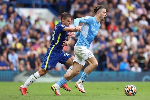 Cesar Azpilicueta of Chelsea is held back by Jack Grealish of Man City during the Premier League match between Chelsea and Manchester City at...