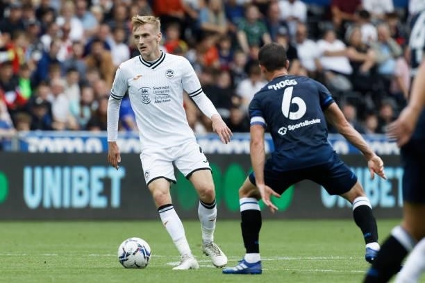 Flynn Downes of Swansea City and Jonathan Hogg of Huddersfield Town in action during the Sky Bet Championship match between Swansea City and...