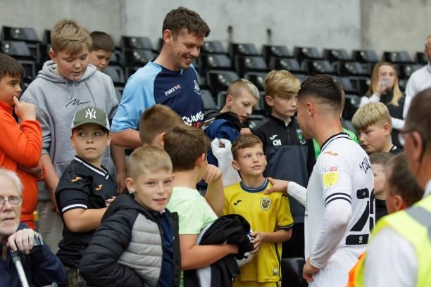 Liam Cullen of Swansea City gives the match ball to a young fan during the Sky Bet Championship match between Swansea City and Huddersfield Town at...