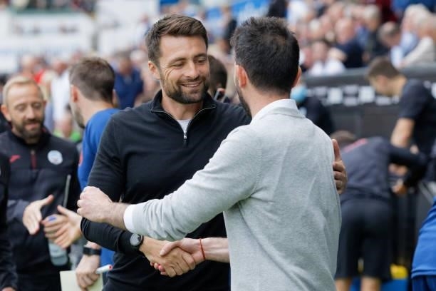 Swansea City manager Russell Martin greets Huddersfield Town manager Carlos Corberan prior to the Sky Bet Championship match between Swansea City and...