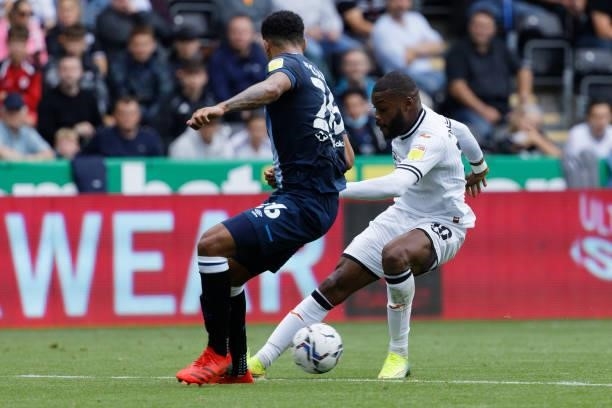 Olivier Ntcham of Swansea City and Jonathan Hogg of Huddersfield Town in action during the Sky Bet Championship match between Swansea City and...