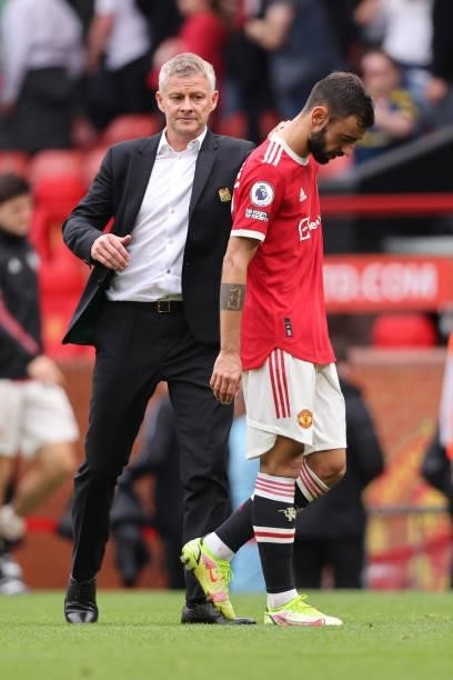 Dejected Bruno Fernandes and Ole Gunnar Solskjaer the manager / head coach of Manchester United walk off dejected after losing to Aston Villa during...