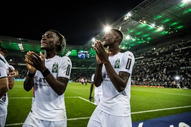 Manu Kone and Denis Zakaria of Borussia Moenchengladbach celebrate with their fans after the Bundesliga match between Borussia Moenchengladbach and...