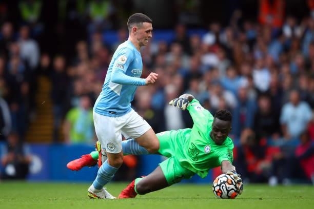 Phil Foden of Manchester City in action with Edouard Mendy of Chelsea during the Premier League match between Chelsea and Manchester City at Stamford...