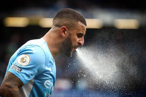 Kyle Walker of Manchester City sprays water during the Premier League match between Chelsea and Manchester City at Stamford Bridge on September 25,...