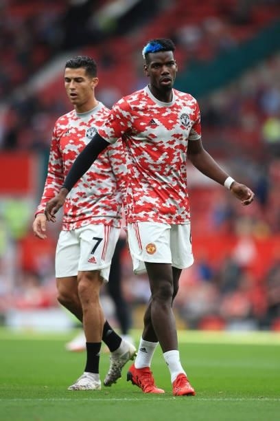 Paul Pogba of Manchester United wamrs up alongside Cristiano Ronaldo of Manchester United before the Premier League match between Manchester United...
