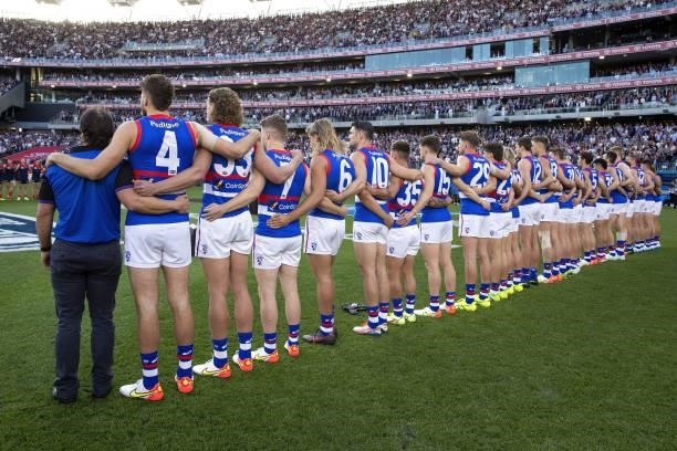 The Western Bulldogs link lineup for the national anthem before the 2021 Toyota AFL Grand Final match between the Melbourne Demons and the Western...