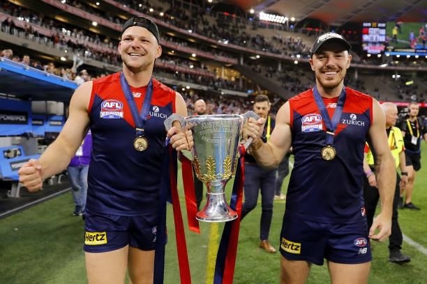 Steven May of the Demons and Michael Hibberd of the Demons celebrate with the premiership cup during the 2021 Toyota AFL Grand Final match between...